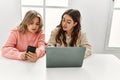 Young couple smiling happy working using laptop and smartphone at home Royalty Free Stock Photo