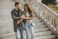 Young couple smiling and talking while strolling down outdoor stairs on autumn day Royalty Free Stock Photo