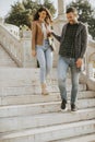 Young couple smiling and talking while strolling down outdoor stairs on autumn day Royalty Free Stock Photo