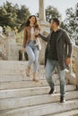 Young couple smiling and talking while strolling down outdoor stairs on autumn day Royalty Free Stock Photo
