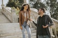 Young couple smiling and talking while strolling down outdoor stairs on autumn day Royalty Free Stock Photo