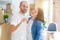 Young couple smiling very happy showing keys of new home, moving and buying new apartmet concept Royalty Free Stock Photo