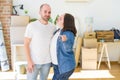 Young couple smiling very happy showing keys of new home, moving and buying new apartmet concept Royalty Free Stock Photo