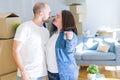 Young couple smiling very happy showing keys of new home, moving and buying new apartmet concept Royalty Free Stock Photo