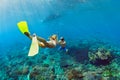 Young couple in snorkeling mask free dive underwater in sea