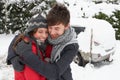 Young couple in snow with car Royalty Free Stock Photo