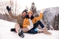 Young couple with snow sleds. Winter vacation