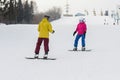 Young couple snowboarders slide down Royalty Free Stock Photo