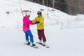 Young couple snowboarders slide down Royalty Free Stock Photo