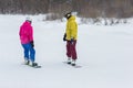 Young couple snowboarders slide down Royalty Free Stock Photo