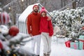 Young couple at snowy backyard on winter time