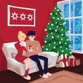 Young couple on sofa and cat in decorated guest room interior with a fireplace. Family celebration. Christmas tree