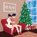 Young couple on sofa and cat in decorated guest room interior with a fireplace. Family celebration. Christmas tree