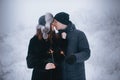 Young couple with sparklers in winter forest. Smiling family with bengal lights. Royalty Free Stock Photo