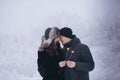 Young couple with sparklers in winter forest. Smiling family with bengal lights. Royalty Free Stock Photo