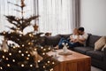 Young couple spending their Christmas holidays at home. Man, moman and their cat Royalty Free Stock Photo
