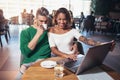 Young couple spending time in cafe watching media to laptop Royalty Free Stock Photo