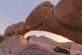 Young couple in Spitzkoppe area with picturesque stone arches and unique rock formations in Damaraland Namibia