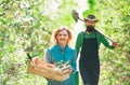 Young couple in spring orchard looking into the camera. Small business owner selling organic fruits and vegetables Royalty Free Stock Photo