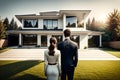 Young Couple standing in front of a modern new house