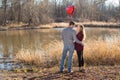 Young couple standing at lake looking into each others eyes Royalty Free Stock Photo