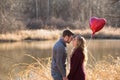 Young couple standing at lake looking into each others eyes Royalty Free Stock Photo