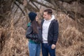 Young couple standing in nature on a winter day, looking at each other Royalty Free Stock Photo