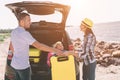 Young couple standing near the opened car boot with suitcases and bags. Dad, mom and daughter are traveling by the sea Royalty Free Stock Photo