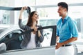 Young Couple Standing Near then New Car and Holding a Key