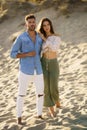 Young couple standing on the sand of the beach Royalty Free Stock Photo