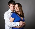 Young couple standing together against a grey wall Royalty Free Stock Photo