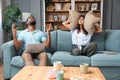 Young couple stares at the ceiling and yells because a neighbor upstairs is having a party with loud music or renovating an