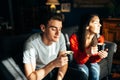 Young couple staying at home,drinking coffee at the window.Enjoying view,sun rays.Serene mornings.Family avoiding social contact. Royalty Free Stock Photo