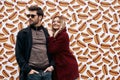 Young couple at the street brand wall background. Wall designed with street food