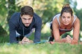 Young couple strengthening their muscles in park Royalty Free Stock Photo