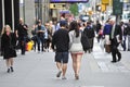 A man and woman holding hands walking