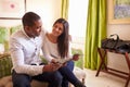 Young couple study a guide brochure together in a hotel room Royalty Free Stock Photo