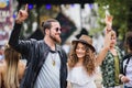 Young couple at summer festival, dancing arm in arm. Royalty Free Stock Photo