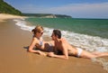 Young couple sunbathing at the beach Royalty Free Stock Photo