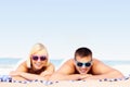 Young couple sunbathing at the beach Royalty Free Stock Photo