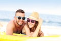 Young couple sunbathing on the beach Royalty Free Stock Photo