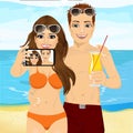 Young couple with sunglasses taking selfie photo together using smartphone camera at the beach Royalty Free Stock Photo