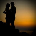 Young couple sunset silhoutte on a coast during holiday Royalty Free Stock Photo