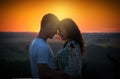 Young couple at sunset on sky background, love concept, romantic people