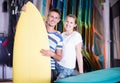 Young couple of surfers is satisfied of choose surfboard Royalty Free Stock Photo