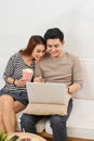 Young couple surfing on internet with laptop. Modern white apart Royalty Free Stock Photo