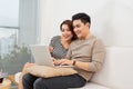 Young couple surfing on internet with laptop. Modern white apartment in background Royalty Free Stock Photo