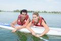 Young couple swiming with paddle board in lake