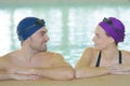 Young couple swimmers inside swimming pool Royalty Free Stock Photo