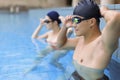 Young couple swimmers preparing to race at the swimming pool Royalty Free Stock Photo